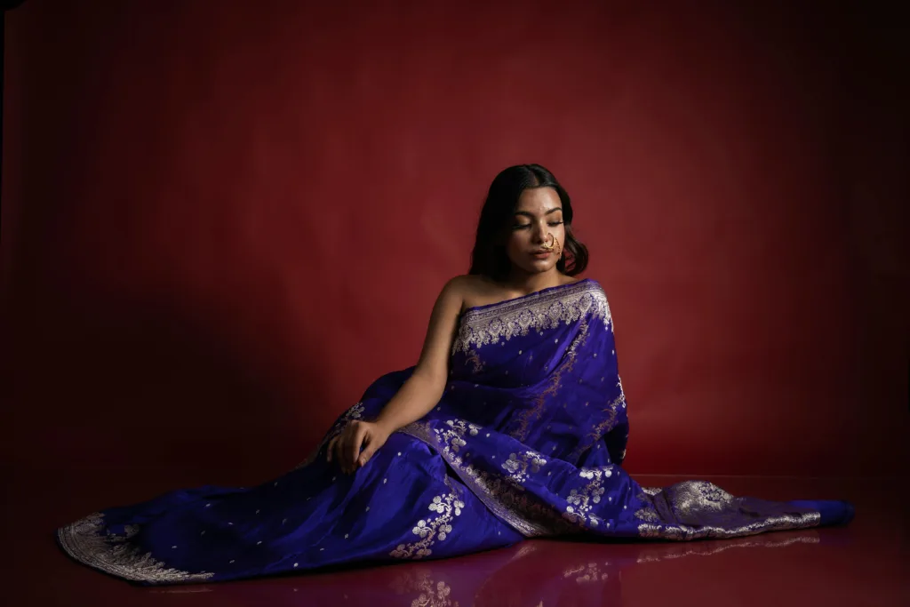 pexels-photo-28517481-28517481 A serene portrait of a woman in a vibrant blue saree, embodying elegance and tradition.