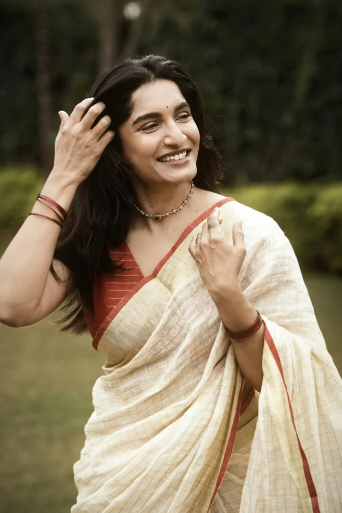 pexels-photo-29538465-29538465 A woman in a traditional sari smiles outdoors, exuding elegance.