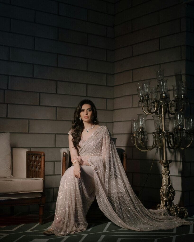 pexels-photo-30249392-30249392 A woman in an elegant saree sitting indoors, exuding grace and poise.