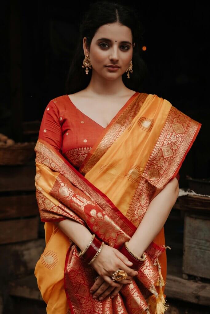 pexels-photo-28943656-28943656 Portrait of a woman in a vibrant traditional Indian saree with intricate jewelry.